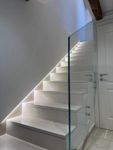 a staircase with a glass case in a house at Ca' Elena beautiful canal view Biennale in Venice