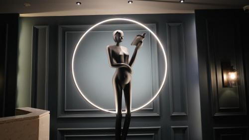 a statue of a woman standing in a circle in a room at Seasons Rajkot in Rajkot