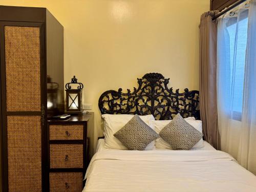 a bedroom with a bed with white sheets and pillows at Park Avenue Boutique Hotel Manila in Manila