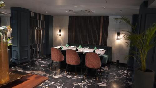 a dining room with a table and chairs at Seasons Rajkot in Rajkot