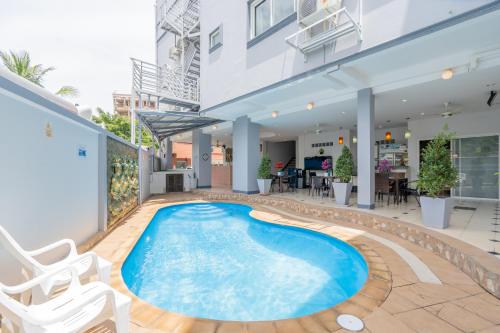 a swimming pool in the middle of a building at Square One Hotel Patong in Patong Beach