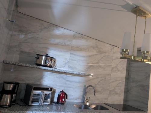a kitchen with a counter with a toaster and a sink at BridgeView Arcadia One in Portmore