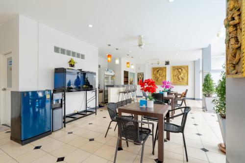 a kitchen and dining room with a table and chairs at Square One Hotel Patong in Patong Beach