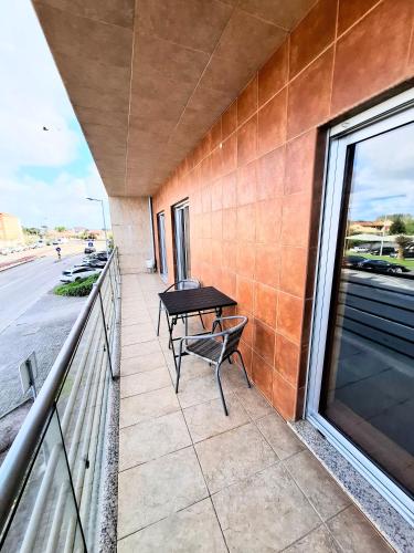 a balcony with a table and a bench on it at Aveiro Atlantic House in Ílhavo
