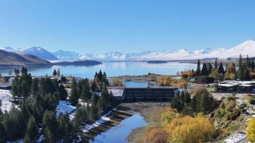 an aerial view of a lake with snow covered mountains at Rivers Edge Villa in Lake Tekapo