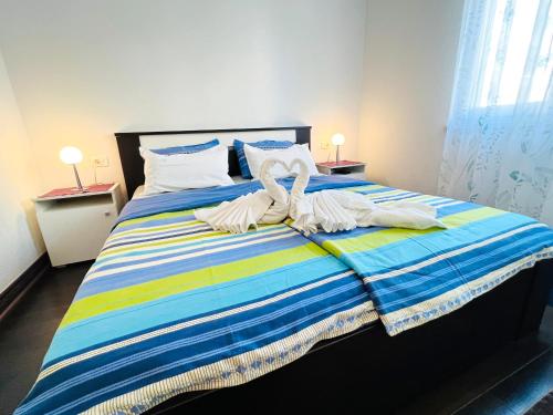 a bedroom with a bed with towels on it at Adria Apartment Makarska in Veliko Brdo