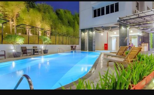 a large blue swimming pool in a building at Nagoya Mansion Apart Trw B in Nagoya