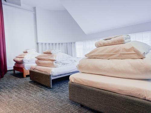 a room with three mattresses stacked on top of each other at UNPLAN Shinjuku in Tokyo
