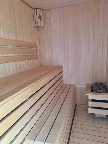a small sauna with a wooden bed in it at Mountain paradise Премиум дача в Чимгане in Chimgan