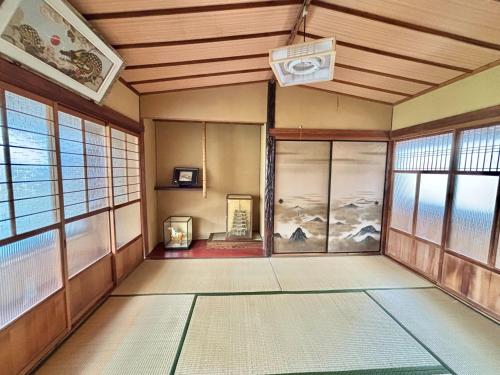 an empty room with a room with windows and a heater at The Grand Stay Shin-Osaka in Osaka
