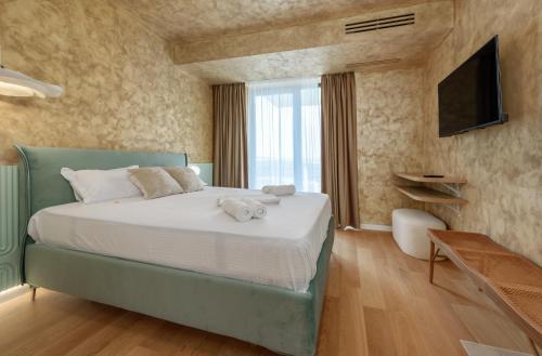 a bedroom with a bed with towels on it at Studio South - VOGH in Olimp