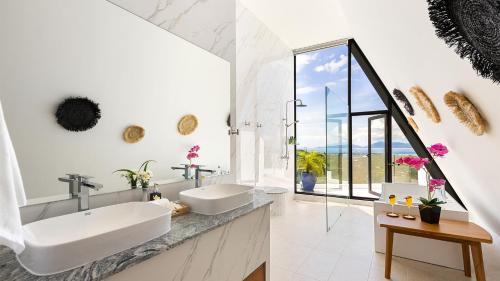 a bathroom with two sinks and a large window at Blue Pearl Villa - Brand new luxury awaits in Koh Samui 