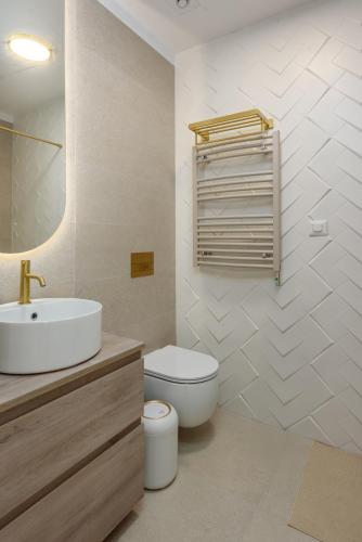 a white bathroom with a sink and a toilet at Studio South - VOGH in Olimp