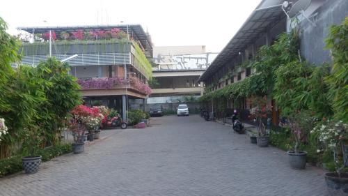 a street with flowers and plants in a building at Taman Paradise Homestay in Surabaya