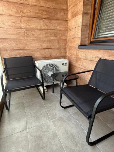 two chairs and a fan sitting on a patio at Apartament DeLuxe Targowa in Garwolin