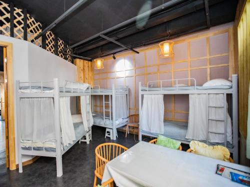 a room with two bunk beds and a table at Elite Guest House in the heart of Downtown Ulaanbaatar in Ulaanbaatar