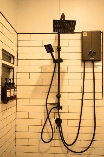 a shower in a bathroom with a black shower head at Runway Tail 145 in Sathani Lat Krabang
