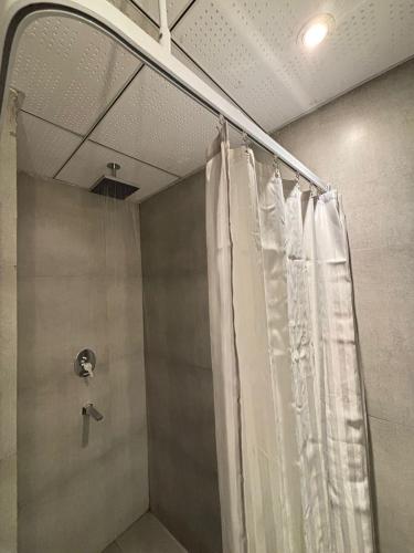 a shower with a shower curtain in a bathroom at luxury apartment in Noida in Noida