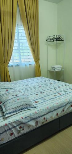 a bed in a bedroom with a window and curtains at Homestay Ummi Baling in Baling