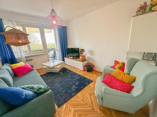 a living room with two couches and a television at Apartament przy Rynku in Sandomierz