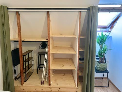 a room with wooden shelves in a room with a window at Charment Appartement Duplex - Pornichet in Pornichet