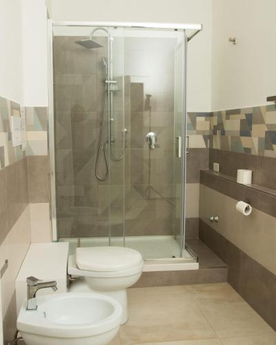a bathroom with a toilet and a glass shower at La Bella Salernitana in Salerno