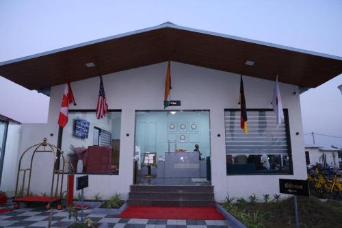 a white building with flags in front of it at SKD RESORT AND CLUB in Barvāla