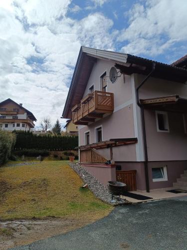 a house with a balcony on the side of it at Haus ElSaVi - Top 1 in Köstendorf