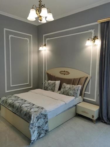 a bedroom with a bed and a table in it at Holiday inn Adnan boutique hotel and pool in Gabala