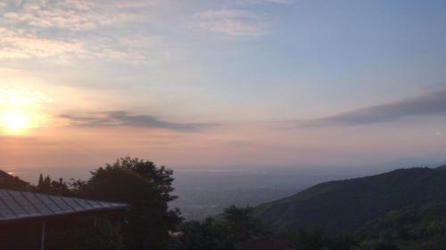 a view of the sun setting over the mountains at Apartment Masho in Sighnaghi