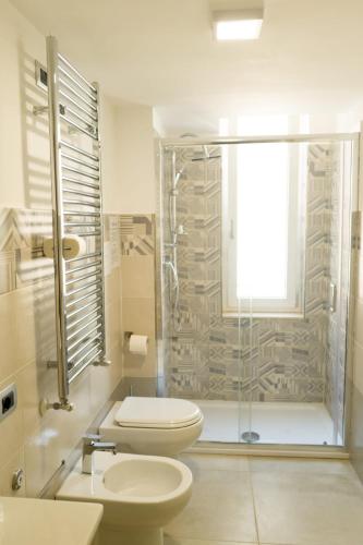 a bathroom with a toilet and a glass shower at La Bella Salernitana in Salerno