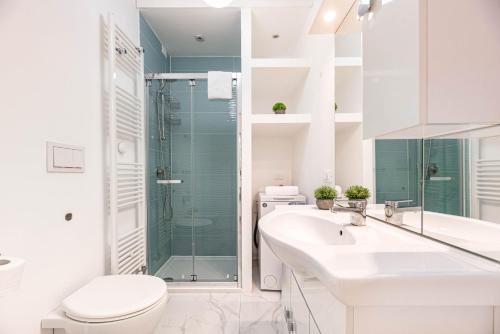 a bathroom with a toilet and a sink and a shower at Italstay - Savonarola courtyard - Free parking in Padova