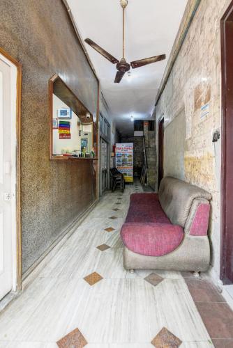 a living room with a couch in the middle of a room at Hotel Bawa Guest House in New Delhi
