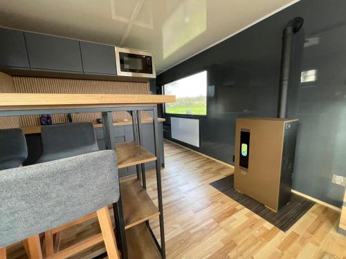 a kitchen with a bar and some chairs and a counter at Houseboat mét sloep in Midlaren