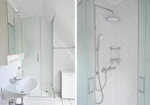 a white bathroom with a shower and a sink at Studio, Nähe Dieksee in Malente