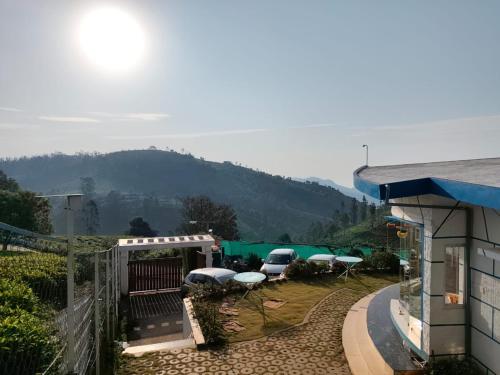 a view of a house with chairs and a patio at DIAMOND HILL VIEW in Ketti