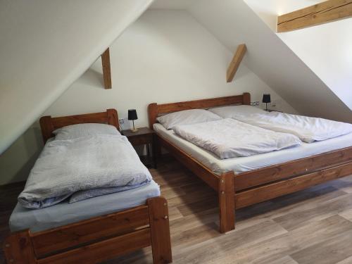 two twin beds in a room with a attic at Dobrotín 7 - Česká Kanada in Dobrotín