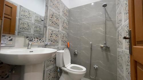 a bathroom with a sink and a toilet and a shower at Midways Guest House and Hotels in Islamabad