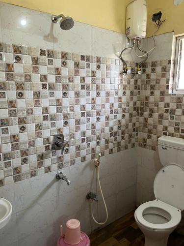 a bathroom with a shower and a toilet and a sink at Comfort Stays Kolkata airport in Salua