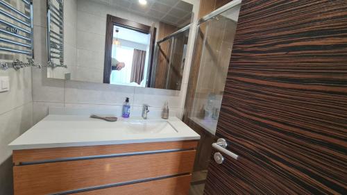 a bathroom with a sink and a mirror and a shower at Modern Furnished Apartments in Istanbul Basaksehir By Iradah Gayrimenkul in Basaksehir
