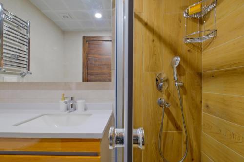 a bathroom with a sink and a shower at Modern Furnished Apartments in Istanbul Basaksehir By Iradah Gayrimenkul in Basaksehir