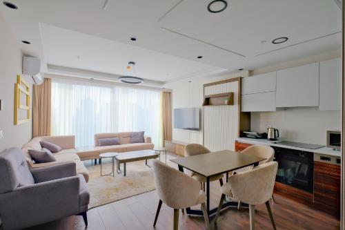 a living room with a couch and a table at Modern Furnished Apartments in Istanbul Basaksehir By Iradah Gayrimenkul in Basaksehir