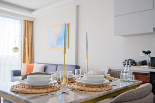 a table with plates and bowls on top of it at Modern Furnished Apartments in Istanbul Basaksehir By Iradah Gayrimenkul in Basaksehir