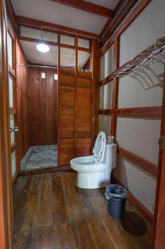 a bathroom with a toilet and a shower at Give Garden Eco ສວນສາຍທານ in Paksong