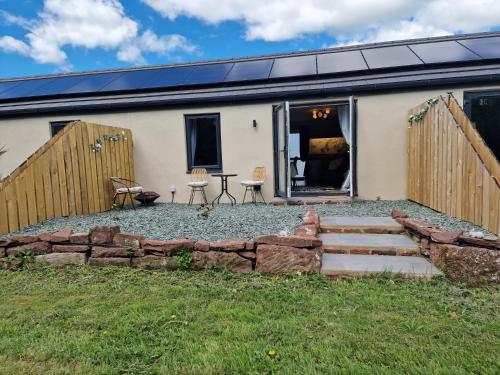 a house with a stone path in front of it at The Burrow by Blake View Holidays a peaceful boutique retreat 3 miles from Ennerdale- standard twin or super-king bed available in Rowrah