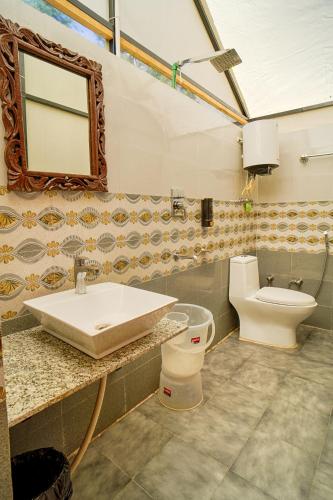 a bathroom with a sink and a toilet at Kabila Camp in Kasol