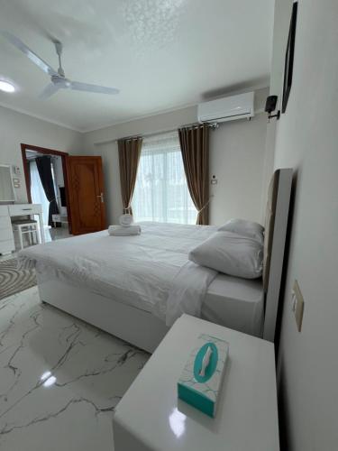 a bedroom with a bed and a table with a box on it at Villa Pure Luxor in Luxor