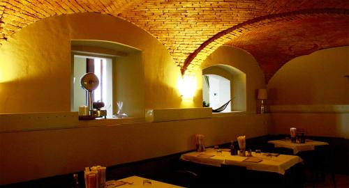 a dining room with two tables and two mirrors at Residenza Borgo in Manerbio