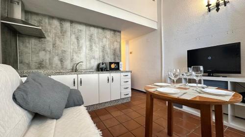 a kitchen with a table with wine glasses on it at Duplex Puente del rey in El Rocío