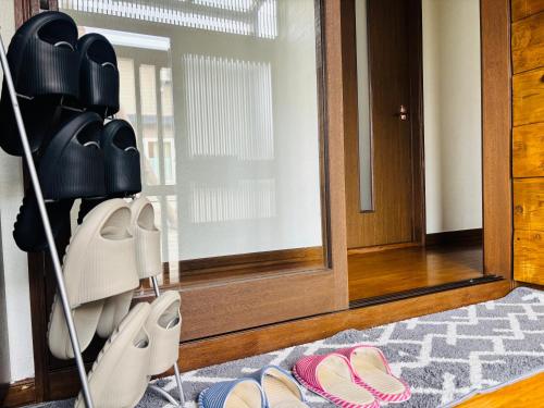 a room with a mirror and a pile of shoes at 富良野 星野家 in Furano
